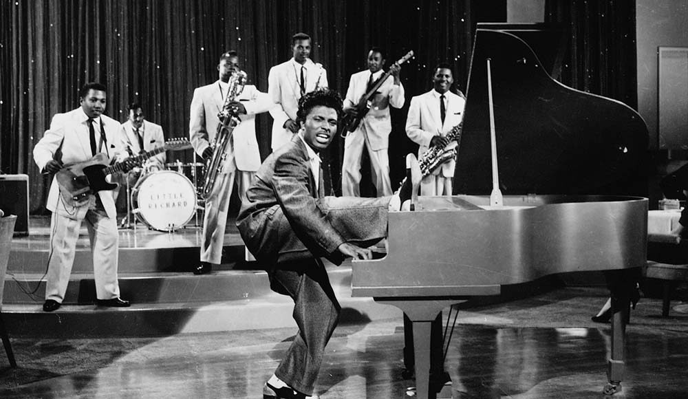 Little Richard with foot on piano